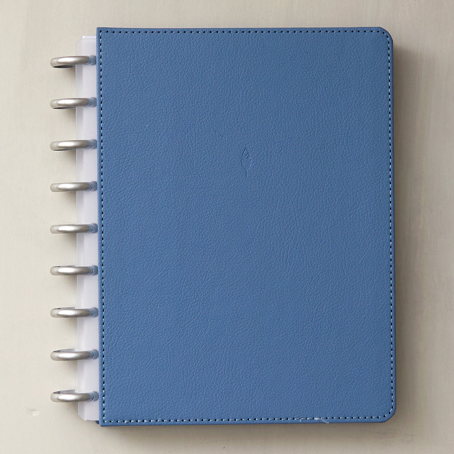 7x9 glacial blue front cover in faux vegan leather with silver discs and clear-white binding