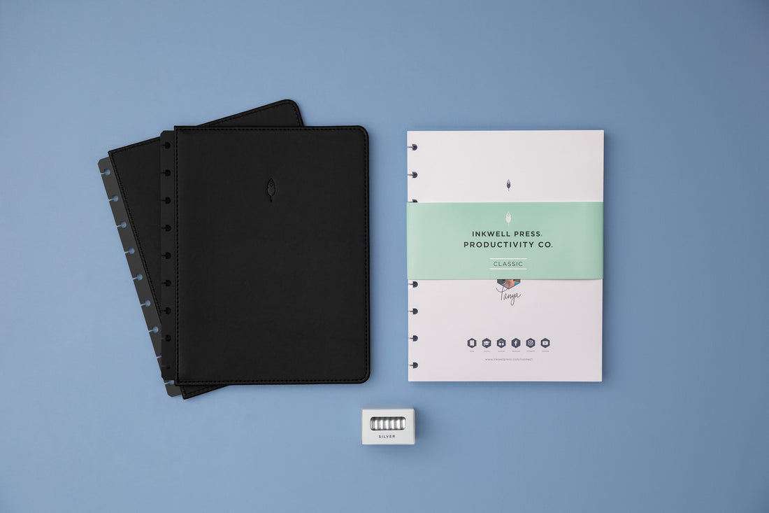 silver disc bound planner with classic inserts and black cover for vertical planning