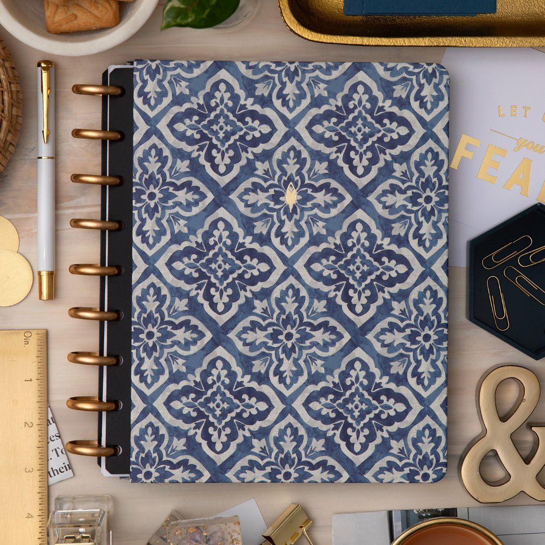 front cover with blue geometric pattern on a desk with office supplies