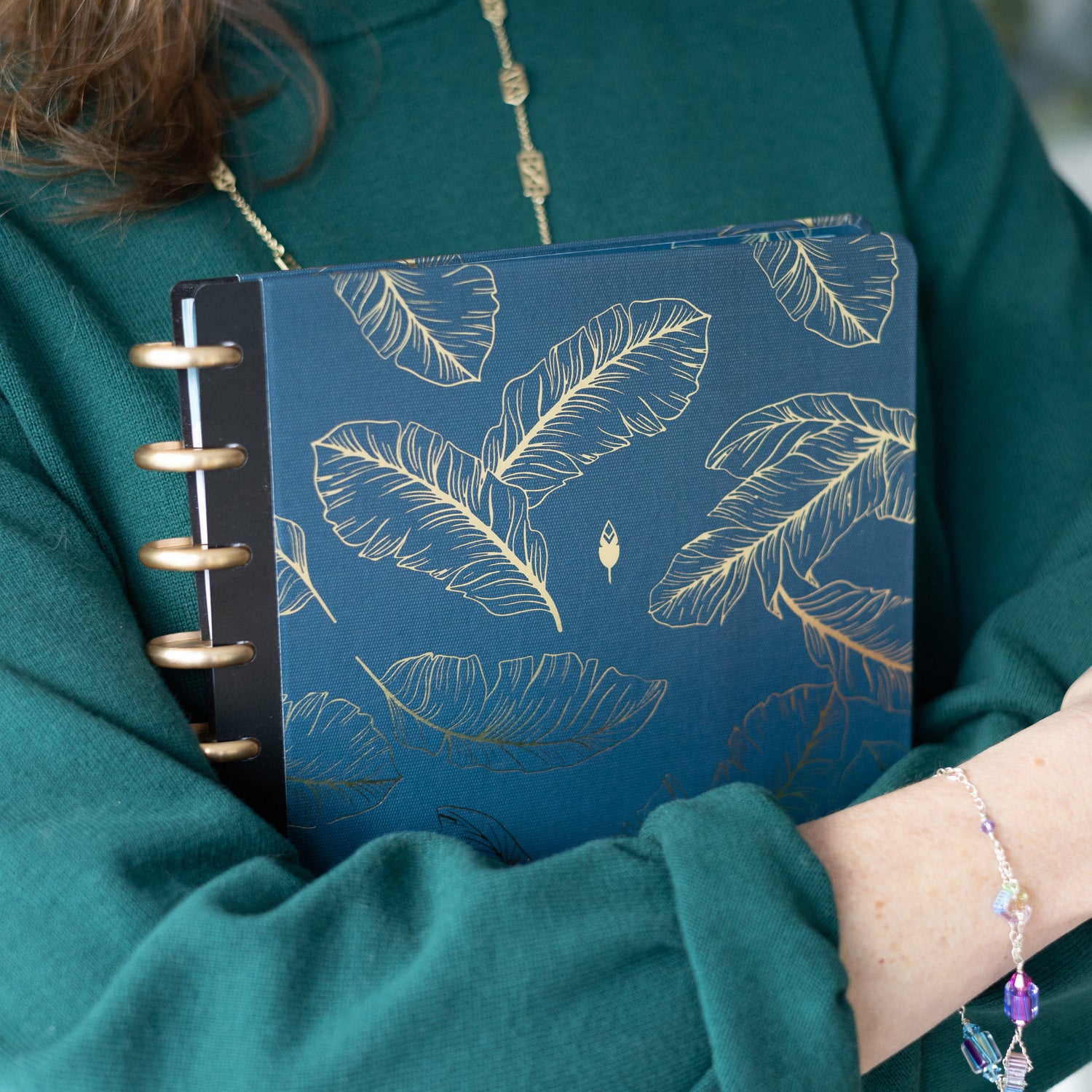 This beautiful classic and signature hard cover features a spread of quill feathers sitting calmly on a navy background